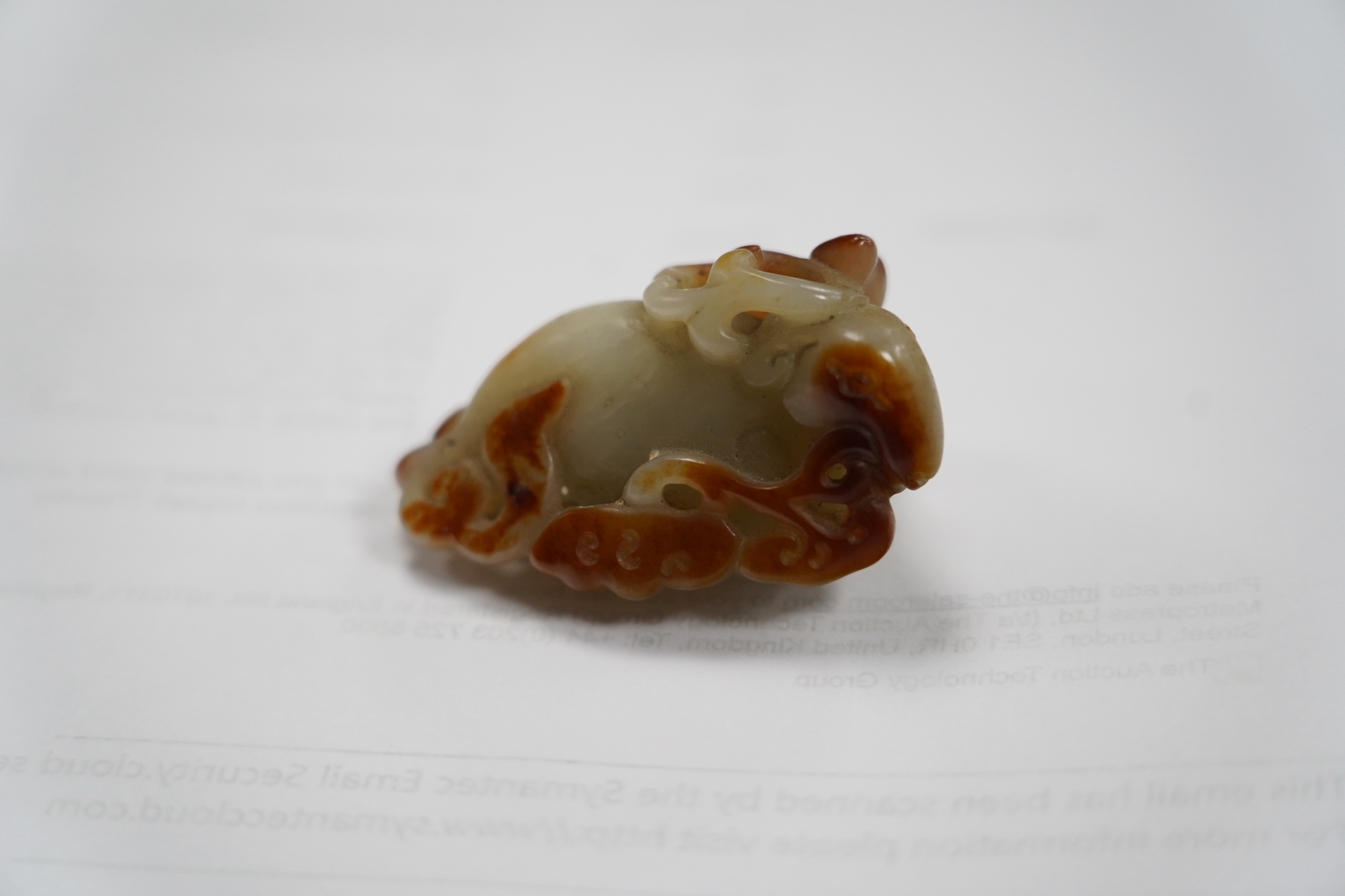 A Chinese pale celadon and russet skin jade figure of a stag, 19th century